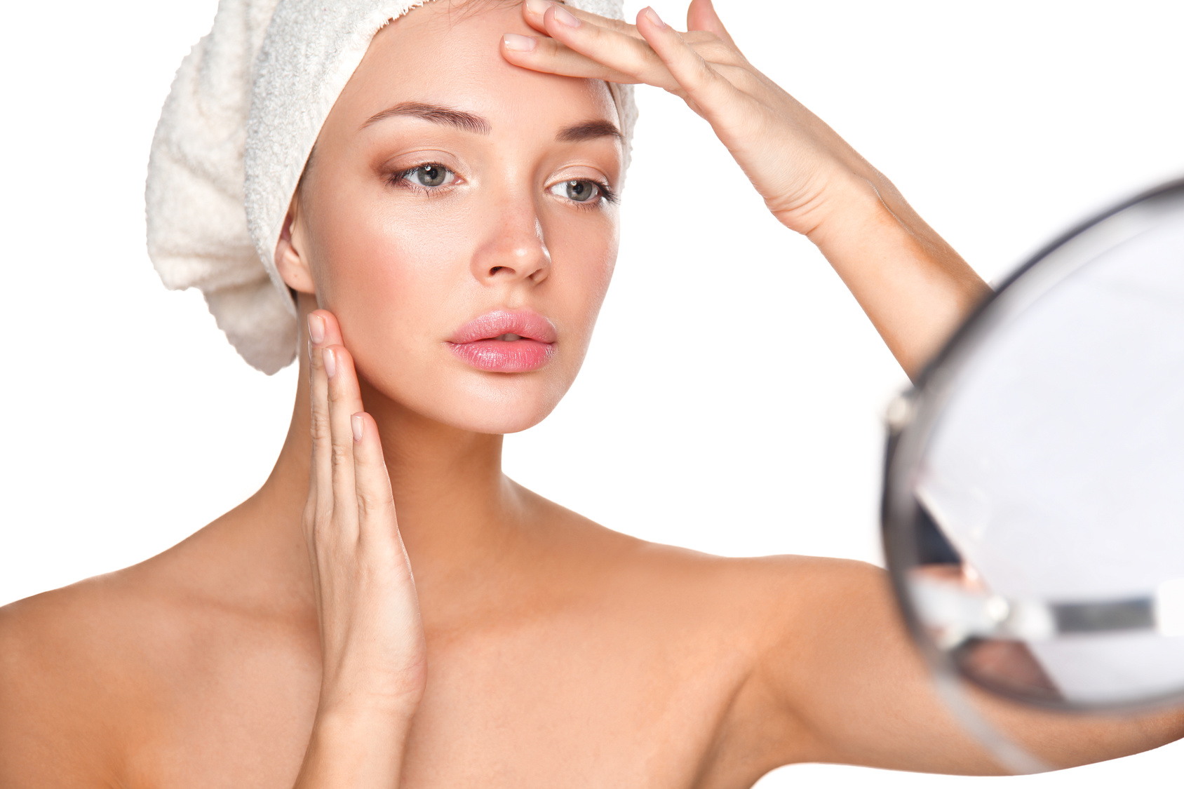 Portrait of beautiful girl touching her face with a towel on her head